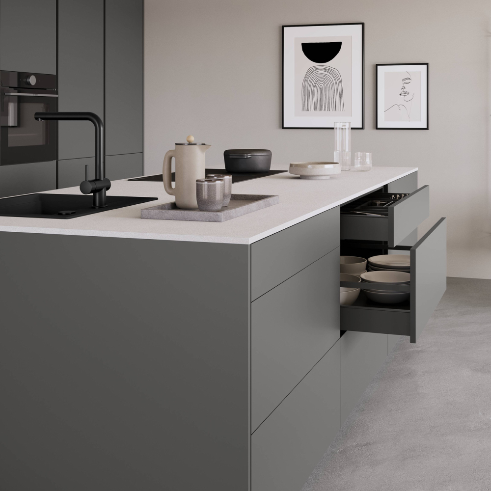 Dark gray kitchen island with open nBOX drawers revealing organized dishes and bowls.