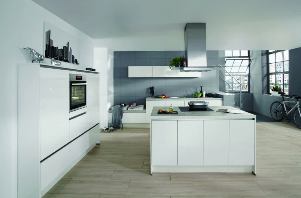 A minimalist white kitchen in a loft-style space. Knowing how to draw a kitchen plan is crucial for maximizing space and functionality in unique layouts.