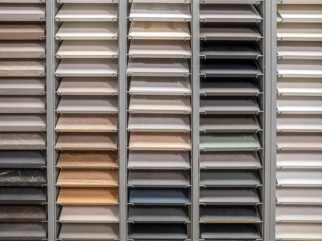 A wide array of cabinet material samples displayed in a German kitchen showroom, offering various colors, textures, and finishes.