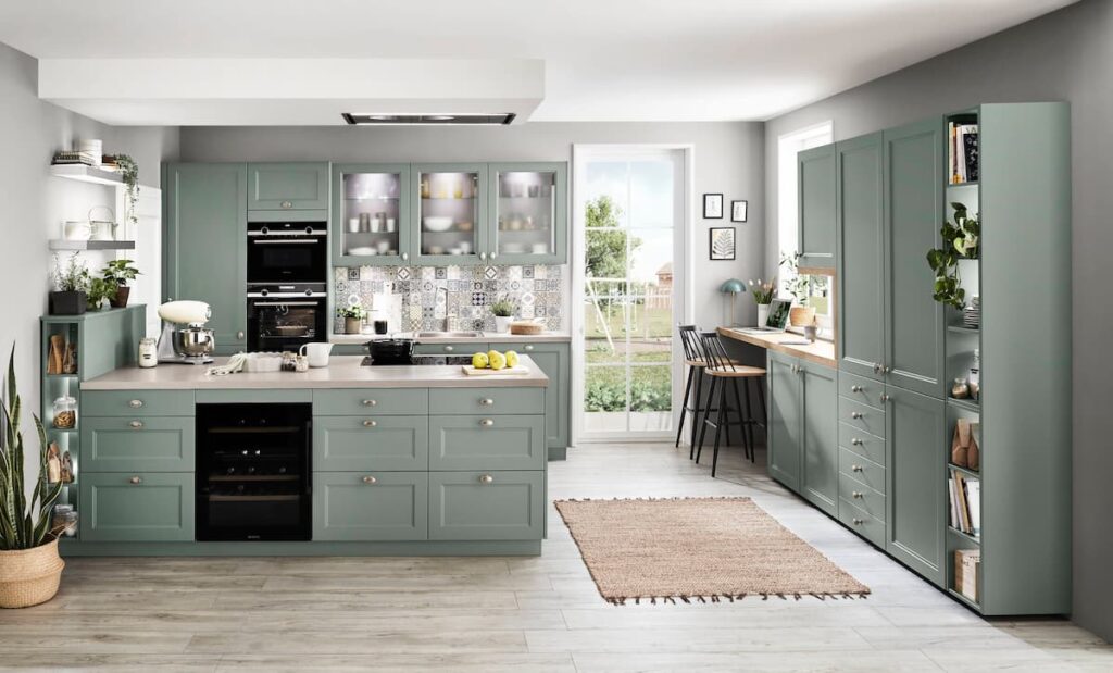 A luxury kitchen featuring green cabinets and open shelving, emphasizing elegant and customized cabinetry.