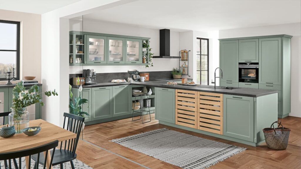 A light green kitchen with wooden panels and dark countertops, integrating eco-friendly materials and natural design elements.