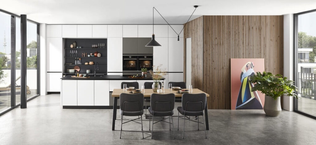 Modern built-in kitchen furniture with sleek white cabinets and a wooden accent wall, perfect for maximizing space and style.