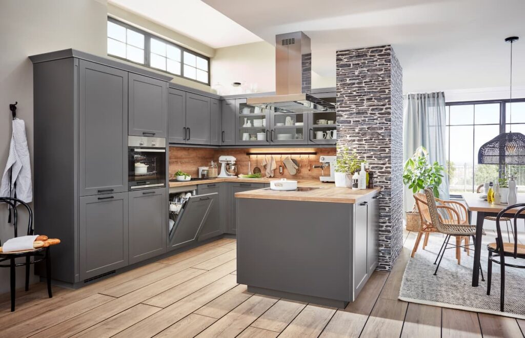 Rustic-inspired kitchen with gray cabinets, wooden countertops, and a cozy dining area