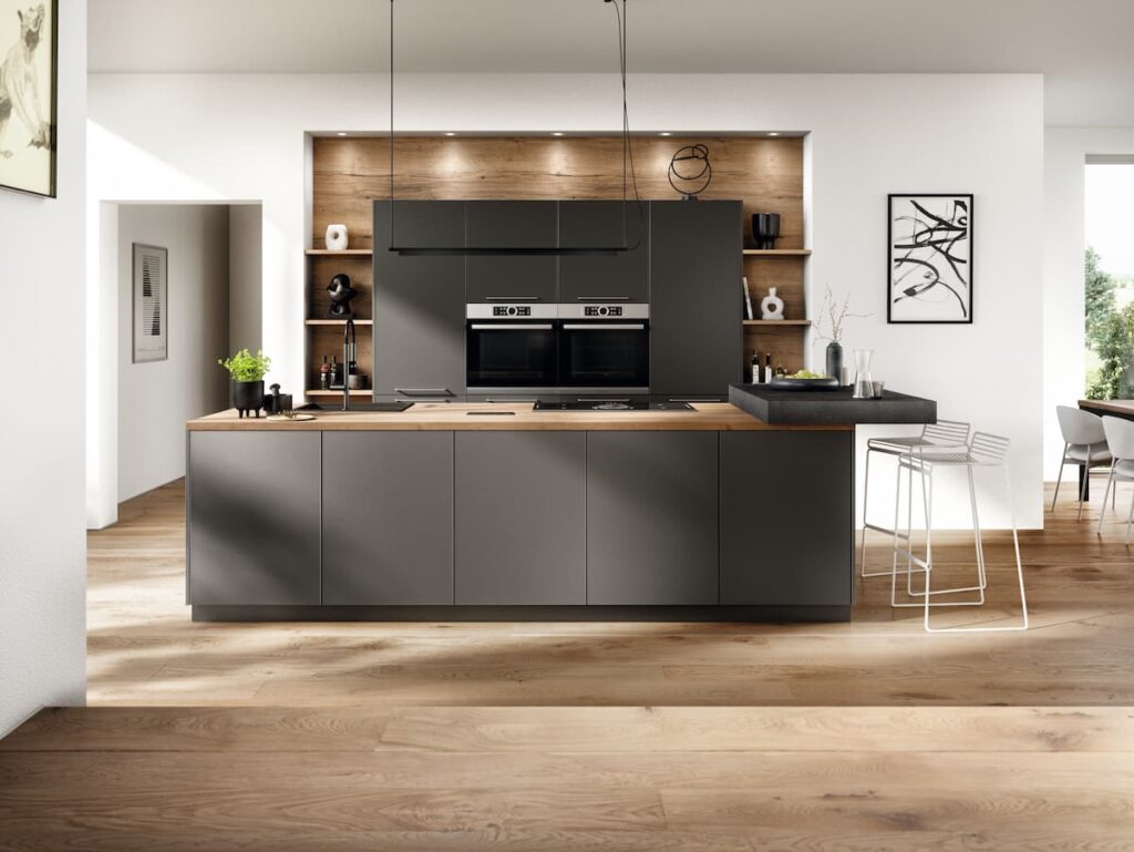 A sleek and minimalist kitchen island design with dark cabinetry and wood accents, displaying a functional and stylish kitchen island design.