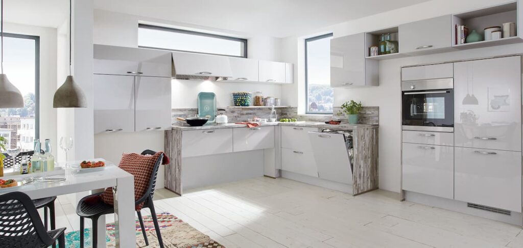 Sleek, modern kitchen showroom with futuristic lighting and high-tech cabinets.